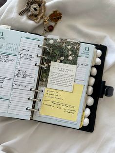 an open planner sitting on top of a bed