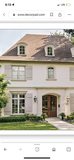 an image of a house with windows and shutters on the front, and side by side