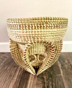 a woven basket sitting on top of a wooden table