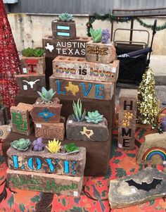 a bunch of boxes that are sitting on the ground in front of some plants and decorations