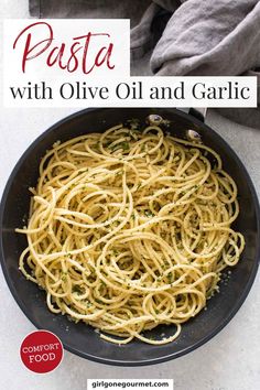 pasta with olive oil and garlic in a skillet on top of a white table