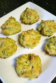 some broccoli muffins are sitting on a white plate and ready to be eaten