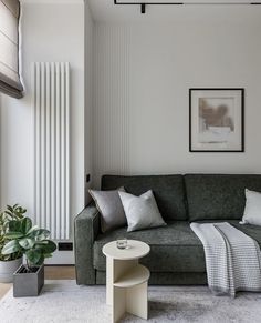 a living room with a couch, table and radiator