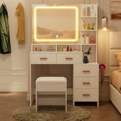 a bedroom with a bed, desk and mirror on the wall next to a closet