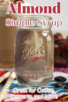 a mason jar filled with coffee sits on a table