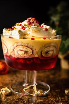 a dessert in a glass dish on a table with christmas decorations around the base and toppings