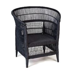 a black wicker chair sitting on top of a white floor