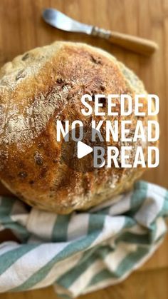 a loaf of no knead bread sitting on top of a blue and white towel