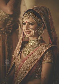 a woman in a bridal outfit with jewelry on her neck and headpieces