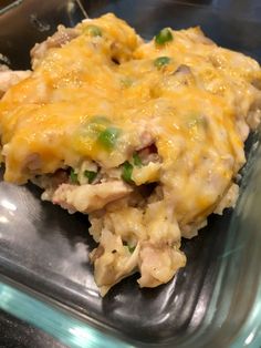 a casserole dish with meat and vegetables in it sitting on a glass plate