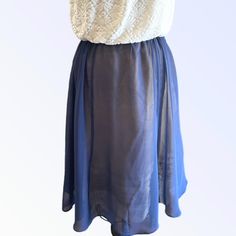 Best Seller - Tie Waist Overskirt in Indigo silk chiffon. Skirt is very versatile and can be worn over a slip, leggings, bathing suit, etc., or wear it as a slip. Pair it with one of our tops for a seamless dressed up look. Now available in Ivory, Indigo, Cloud Blue, Pistachio and Vintage Rose. One Size fits most. - princess seams - drawstring ties To prevent shrinkage, hand wash in cold water, hang to dry, or dry cleaning is recommended. Please email for additional information and before placin Elegant Sheer Voluminous Skirt, Chic Flowy Full Skirt Bottoms, Elegant Summer Skirt With Elastic Waistband, Fitted Dress With Elastic Waistband And Flared Skirt, Fitted Flared Skirt Dress With Elastic Waistband, Elegant Full Maxi Skirt For Beach, Chic Sheer Flowy Skirt, Chic Sheer Tiered Skirt, Chic Sheer Flowy Maxi Skirt