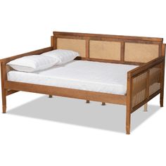 a wooden bed frame with white sheets and pillows