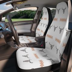 the interior of a car with an animal pattern on it's front seat cover