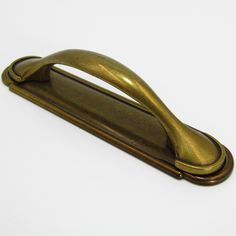 an antique brass door handle on a white background