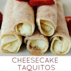 there are four pieces of cheesecake taquitos on the plate with strawberries