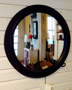 a mirror hanging on the side of a wall