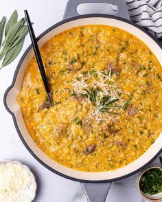 a large pot filled with soup and topped with parmesan cheese