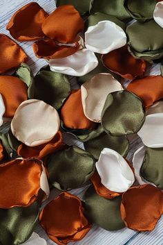 several different colors of fabric flowers on a table