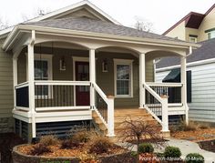 a small house with porches and steps leading to the front door