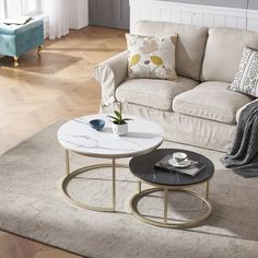 a living room filled with furniture and a white coffee table on top of a rug