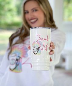 a woman holding up a white cup with the words send off on it