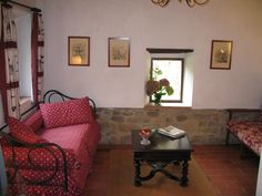 a living room with two couches and a coffee table in front of a window