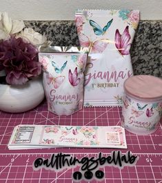 the contents of a birthday party are displayed on a pink counter top with flowers and cards