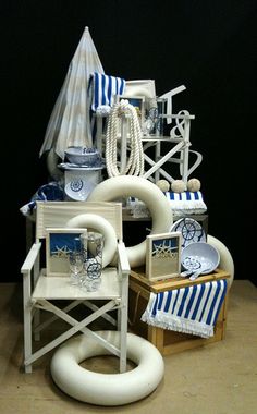 an assortment of beach chairs and umbrellas on display in front of a black background