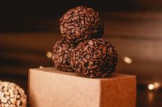 three balls of chocolate sitting on top of a box