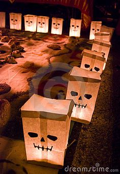 paper bags with faces on them are lined up in the shape of jack - o'- lanterns