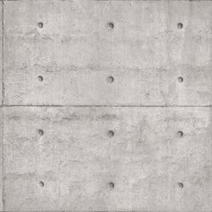 a concrete wall with holes in it