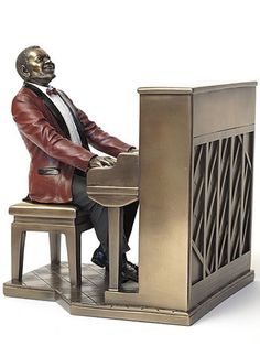 a statue of a man sitting at a piano