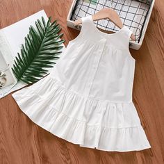 Sleeveless Cotton Midi Dress With Ruffles, Cute Sleeveless Solid Color Dress, Solid Color Summer Sleeveless Dress With Ruffles, Sleeveless Cotton Sundress With Ruffle Hem, Cute Sleeveless Dresses, Cotton Sleeveless Dress For Summer Playdate, Summer Cotton Sleeveless Dress For Playdate, Spring Sleeveless Dress For Playdate, White Cotton Sleeveless Dress With Ruffles