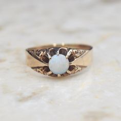 Antique Victorian 14k gold ring with a round opal cabochon set in a belcher claw setting. The top corners of the band are decorated with a scrolling design. The inside of the band is inscribed W.C.A. Era: Victorian c.1880s Markings: None Materials: 14k gold, opal Ring Size: 9.5 (comes with one free resizing by our jeweler) Weight: 3.4 grams Condition: Excellent antique condition with minor surface wear from age  Shipping is free in the United States Follow us on Instagram @LUXXORVintage 14k Gold Opal Ring, Gold Opal Ring, Opal Ring Gold, Claw Setting, 14k Gold Ring, Opal Ring, Antique Victorian, Opal Rings, Rings Statement