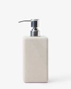 a white soap dispenser on a white background