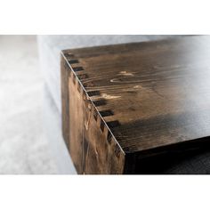 a wooden box sitting on top of a carpeted floor