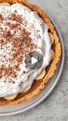 a pie topped with whipped cream and chocolate sprinkles sitting on top of a plate