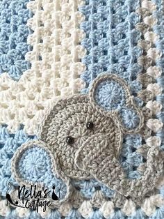 a blue and white crocheted blanket with a teddy bear on the front side