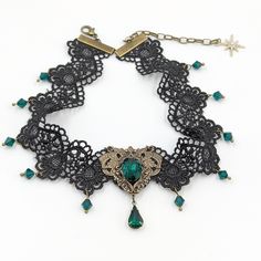 This vintage gothic styled crystal lace choker necklace features lush Emerald Swarovski crystals with nice crisp facets and brass embellishments. The detailed stampings have been in production since the 1940's and the vintage 16x11mm focal crystal is no longer in production, making this necklace a rare find.Both elegant and stylish, this piece would be perfect for any formal occasion.Swarovski Crystals are made in Austria and are the highest quality lead free glass-cut crystals on the market, wi Ornate Party Choker Jewelry, Victorian Metal Choker For Gift, Victorian Metal Choker As Gift, Steampunk Choker Jewelry Gift, Victorian Metal Choker Gift, Vintage Jeweled Choker For Parties, Antique Choker Necklace For Party, Vintage Metal Choker For Wedding, Vintage Jeweled Choker As Gift