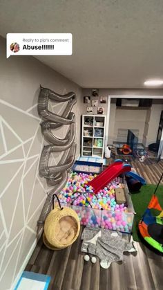 a room filled with lots of toys and other items on the floor in front of a wall