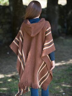 Hooded rustic poncho with brown and white stripes. Handmade in alpaca and lamb wool, this poncho will keep you warm in cold winter days.Overview: Material: Wool Blend. Color: Brown. Crewneck Hooded Size:Length: 90 cm (35.43")Width: 110 cm (43.30")It refers to the total measurements of the poncho when it is fully open (like a blanket)Note: Since this garment is hand-crafted, there might be some variations in color and details of descriptions. Cozy Brown Poncho For Outdoor, Cozy Brown Hooded Poncho, Brown Alpaca Poncho For Winter, Bohemian Hooded Brown Poncho, One Size Brown Poncho For Winter, Brown One Size Poncho For Winter, Brown Alpaca Winter Cape, Brown Long Sleeve Poncho For Outdoor, One-size-fits-all Brown Winter Poncho