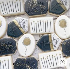 decorated cookies with black and white icing are arranged in the shape of hair combs