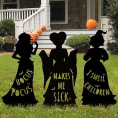 three halloween yard decorations in front of a house