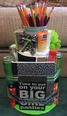 a container with pens, pencils and other items in it