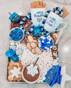 a tray filled with cookies, marshmallows, and other treats for hanukkah