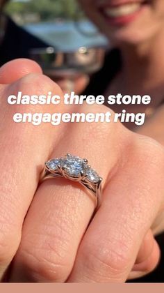 a close up of a person holding a wine glass with a diamond ring on it