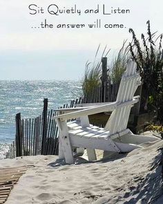 a white beach chair sitting on top of a sandy beach next to the ocean with an inspirational quote above it