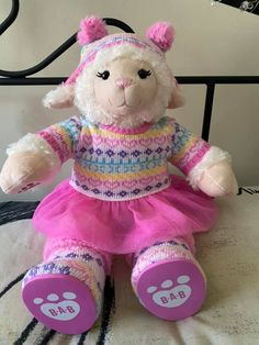 a stuffed animal wearing a pink dress and hat