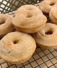 some sugared donuts are on a cooling rack