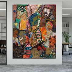 an abstract painting is hanging on the wall